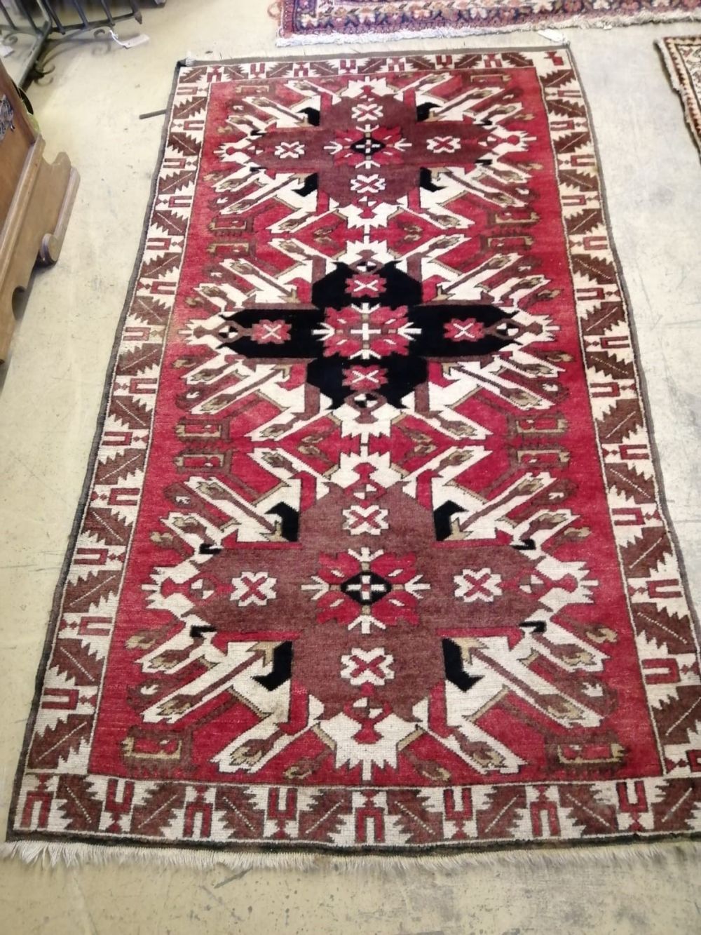 A Kazak red ground rug, 180 x 105cm